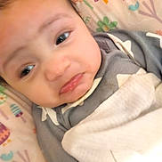 Elijah joined the competition — help win amazing prizes! baby, infant, face, blanket, clothing, pattern, owl, flower, mushroom, expression, close_up, cute, child, person, soft, indoors, lying_down, colorful, swaddled, young