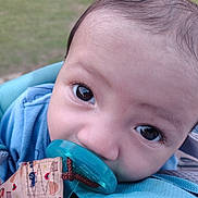 Elijah is registered to the contest to win money with this photo: baby, pacifier, blue, face, closeup, infant, child, outdoor, curious, eyes, carrier, fabric, cute, head, skin, person, young, expression, comfort, soft