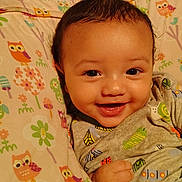 Elijah joined the competition — help win amazing prizes! baby, child, closeup, clothing, colorful, cute, face, hand, happy, indoors, infant, owl_pattern, pattern, person, pillow, portrait, sleeping_area, smiling, soft, young