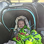 baby, car_seat, blanket, smiling, infant, vehicle_interior, child, seatbelt, window, sunlight, happy, clothing, headrest, car, transportation, seat, people, interior, safety, child_seat