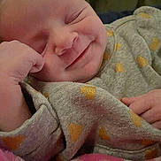 Kaycee joined the competition — help win amazing prizes! baby, infant, child, smiling, sleeping, closed_eyes, face, cheek, hand, onesie, heart_pattern, blanket, pink_blanket, cozy, portrait, indoors, soft_texture, newborn, cute, close_up