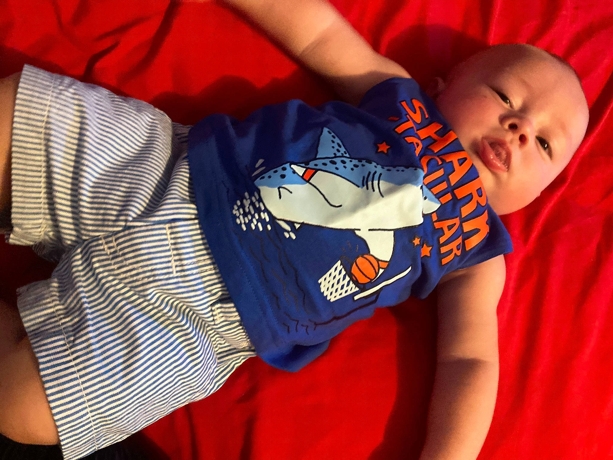 Franklin is registered to the contest to win money with this photo: arm, baby, baby_toddler_clothing, comfort, cool, elbow, electric_blue, finger, fun, glasses, happy, joint, mouth, orange, person, sleeve, t_shirt, textile, thigh, toddler