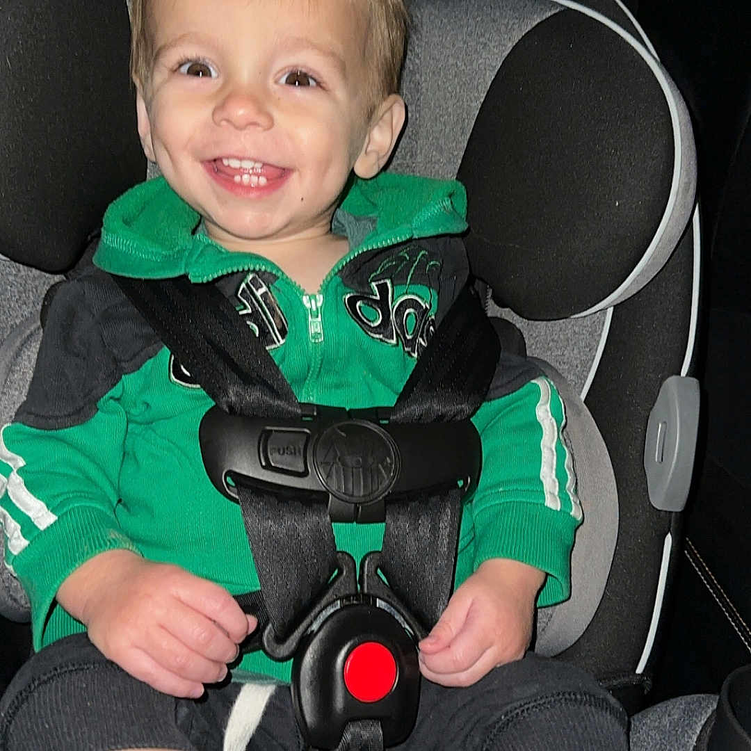 Tatum joined the competition — help win amazing prizes! baby, bodypart, clothing, coat, cushion, face, finger, footwear, glove, hand, head, homedecor, jacket, pants, person, photography, portrait, shoe, sitting, transportation