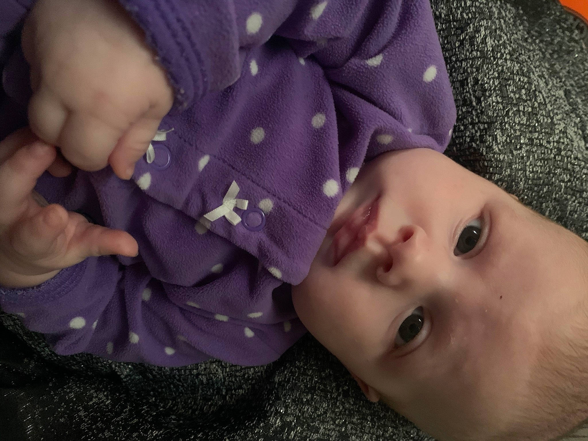 Zeppelin is registered to the contest to win money with this photo: baby, baby_toddler_clothing, cheek, child, comfort, eyebrow, eyelash, facial_expression, gesture, iris, lip, mammal, mouth, nose, pattern, person, purple, skin, thumb, toddler