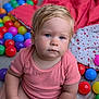 Lise participe au concours pour gagner de l'argent avec cette photo : toddler, baby, child, pink_onesie, blue_eyes, blond_hair, plastic_balls, ball_pit, blanket, indoor, floor, portrait, cute, serious_expression, playtime, colorful, soft_lighting, closeup, sitting, infant