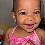 baby, smiling, child, face, pink_clothing, earrings, hand, rainbow_nails, butterfly, tank_top, skin, portrait, cute, happy, indoor, closeup, person, infant, young_child, joyful