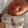 baby, sleeping, smile, pajamas, infant, cozy, blanket, pillow, cute, peaceful, newborn, face, hand, child, resting, soft, indoors, portrait, skin, young