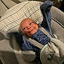 baby, infant, smile, blue_clothing, baby_seat, straps, blanket, cheerful, cute, indoors, cushion, baby_bouncer, happy, small_arms, head, face, newborn, soft_toys, cozy, child