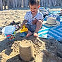 toddler, child, beach, sandcastle, sand, shovel, bucket, hat, sunlight, mat, playing, happy, summer, outdoor, vacation, barefoot, clothing, toy, fun, daytime