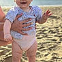 Tessa participe au concours pour gagner de l'argent avec cette photo : baby, child, beach, sand, ocean, smile, happy, person, hand, clothing, diaper, summer, outdoor, sunlight, portrait, cute, support, nail_polish, striped_shirt, feet