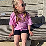 bench, black_shorts, braided_hair, casual, child, concrete, cool, daytime, fashion, girl, outdoor, pink_shirt, portrait, relaxed, shadow, sitting, sunglasses, sunlight, wood, young