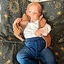 Bobby joined the competition — help win amazing prizes! baby, infant, child, blue_eyes, brown_vest, white_shirt, denim_pants, barefoot, blanket, celestial_pattern, stars, moon, sun, constellation, indoor, portrait, cute, cozy, relaxed, laying_down