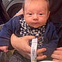 baby, child, infant, person, face, hand, clothing, jacket, checkered_shirt, table, salad, bowl, food, indoor, seat, holding, cute, expression, skin, hair