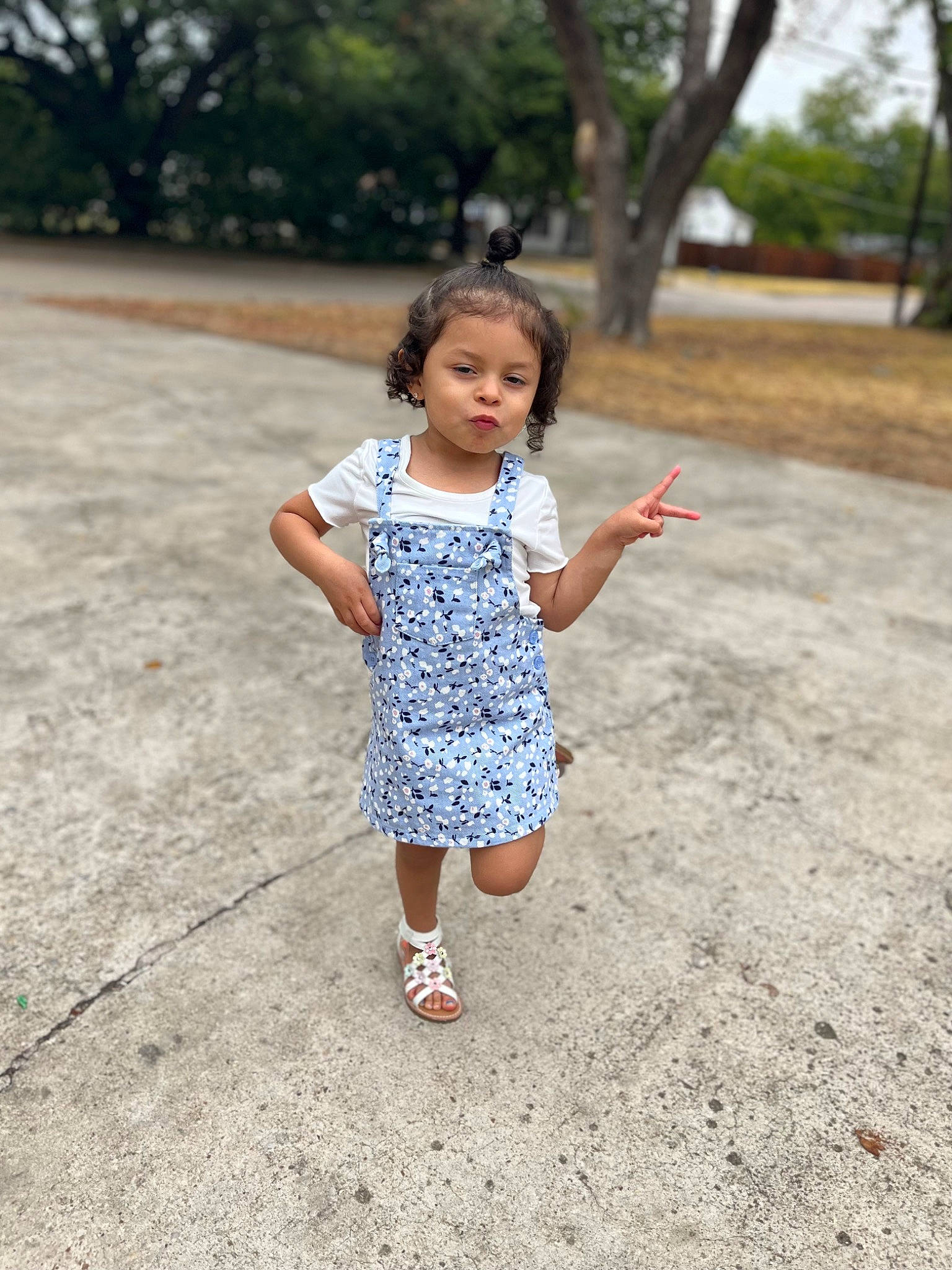 Alanna is registered to the contest to win money with this photo: asphalt, child, fun, grass, happy, leisure, pattern, person, plant, recreation, road, road_surface, sleeve, spring, summer, t_shirt, toddler, tree, vacation, waist