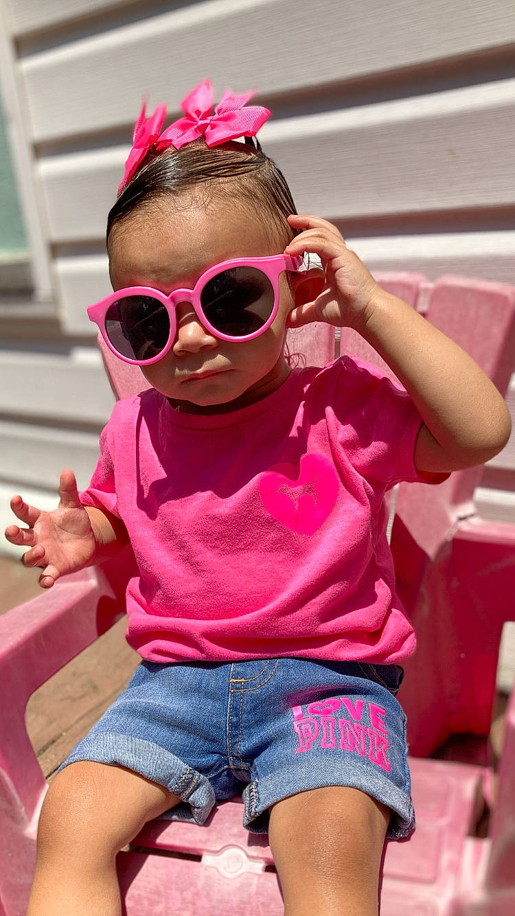 Amya is registered to the contest to win money with this photo: baby_toddler_clothing, cool, eyewear, glasses, goggles, hairstyle, happy, headgear, jean_short, leisure, magenta, person, pink, purple, red, shorts, sleeve, sunglasses, thigh, toddler