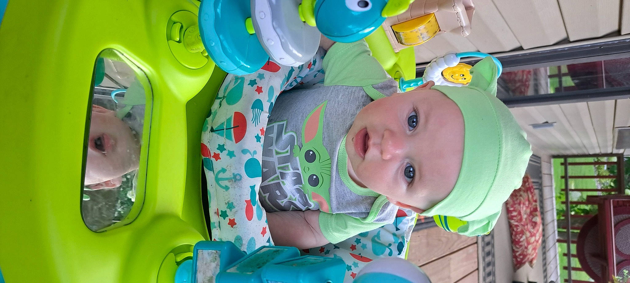 Dennis is registered to the contest to win money with this photo: baby, baby_products, baby_toddler_clothing, baby_toys, child, circle, facial_expression, fun, green, happy, head, headwear, leisure, person, plastic, play, room, smile, toddler, toy