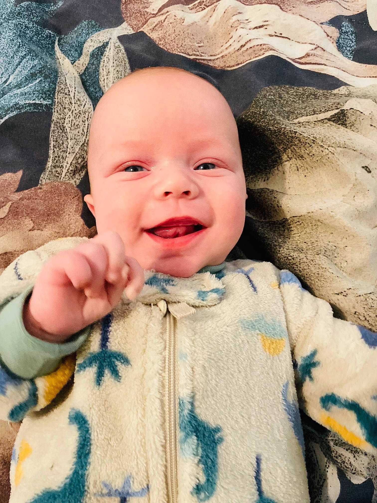Leo is registered to the contest to win money with this photo: baby, baby_laughing, baby_toddler_clothing, cheek, child, chin, eye, eyebrow, face, gesture, happy, iris, linens, nose, outerwear, person, skin, sleeve, smile, textile