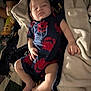 Alejandro is registered to the contest to win money with this photo: baby, sleeping, onesie, crab_pattern, blanket, plush_toy, soft_fabric, cozy, indoor, child, infant, resting, cute, comfort, person, bed, arm, leg, face, nap