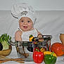 apron, baby, bell_pepper, chef_hat, cherry_tomatoes, child, cooking_pot, eggplant, green_pepper, infant, portrait, pumpkin, red_pepper, smiling, stainless_pot, studio_background, vegetables, wooden_spoons, yellow_pepper, zucchini