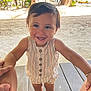 Gael is registered to the contest to win money with this photo: toddler, child, smiling, holding_hands, sand, beach, wooden_deck, sunlight, outdoor, trees, summer_clothing, stripes, sandals, happy, cute, portrait, nature, vacation, baby, playful