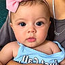 Evelynn joined the competition — help win amazing prizes! baby, infant, child, portrait, close_up, wide_eyed, pink_bow, headband, blue_clothing, smiling, face, eyes, lips, being_held, adult, indoor, photography, closeup_portrait, cute, safe