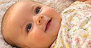 Evelynn is registered to the contest to win money with this photo: baby, infant, child, smiling, portrait, lying_down, blanket, floral_clothing, plush_toy, bunny, flowers, daisies, pink, pastel, nursery, cozy, soft_blanket, indoor, close_up, happy