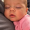 baby, sleeping, infant, portrait, close_up, face, eyes_closed, peaceful, cozy, pink_clothing, soft_lighting, indoors, snuggling, cuddling, baby_clothes, head, cheeks, photography, resting, adorable