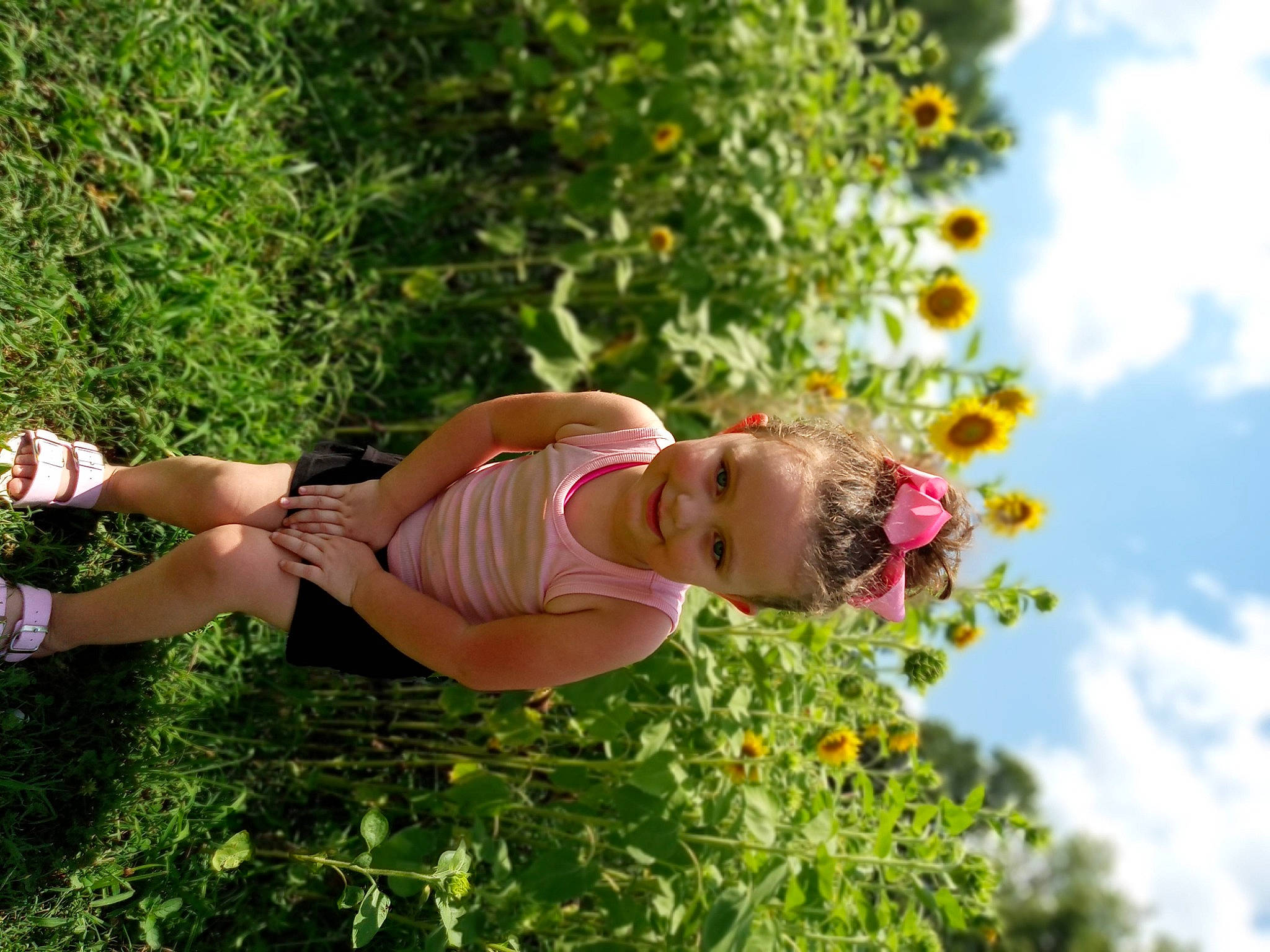 Gabriella is registered to the contest to win money with this photo: cloud, elbow, eyewear, flower, flowering_plant, fruit, fun, grass, hand, happy, human_leg, joy, leisure, people_in_nature, person, plant, shrub, sky, smile, thigh