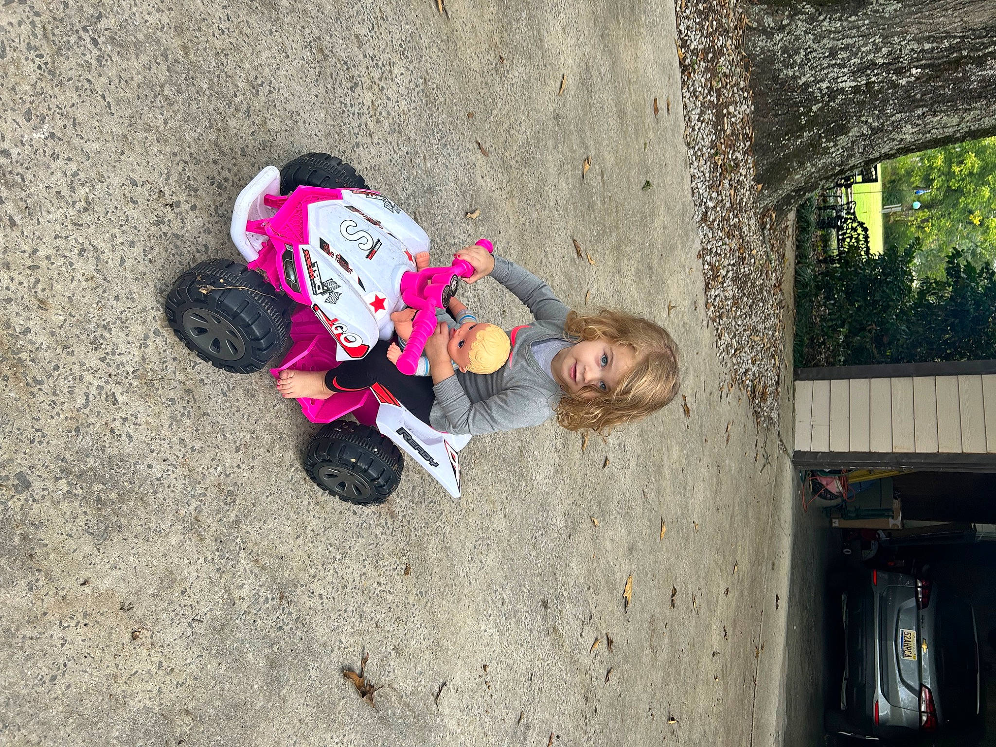 Ainsley joined the competition — help win amazing prizes! asphalt, child, concrete, fun, happy, leisure, magenta, person, recreation, road, road_surface, shadow, sidewalk, sitting, soil, street, toddler, tree, visual_arts