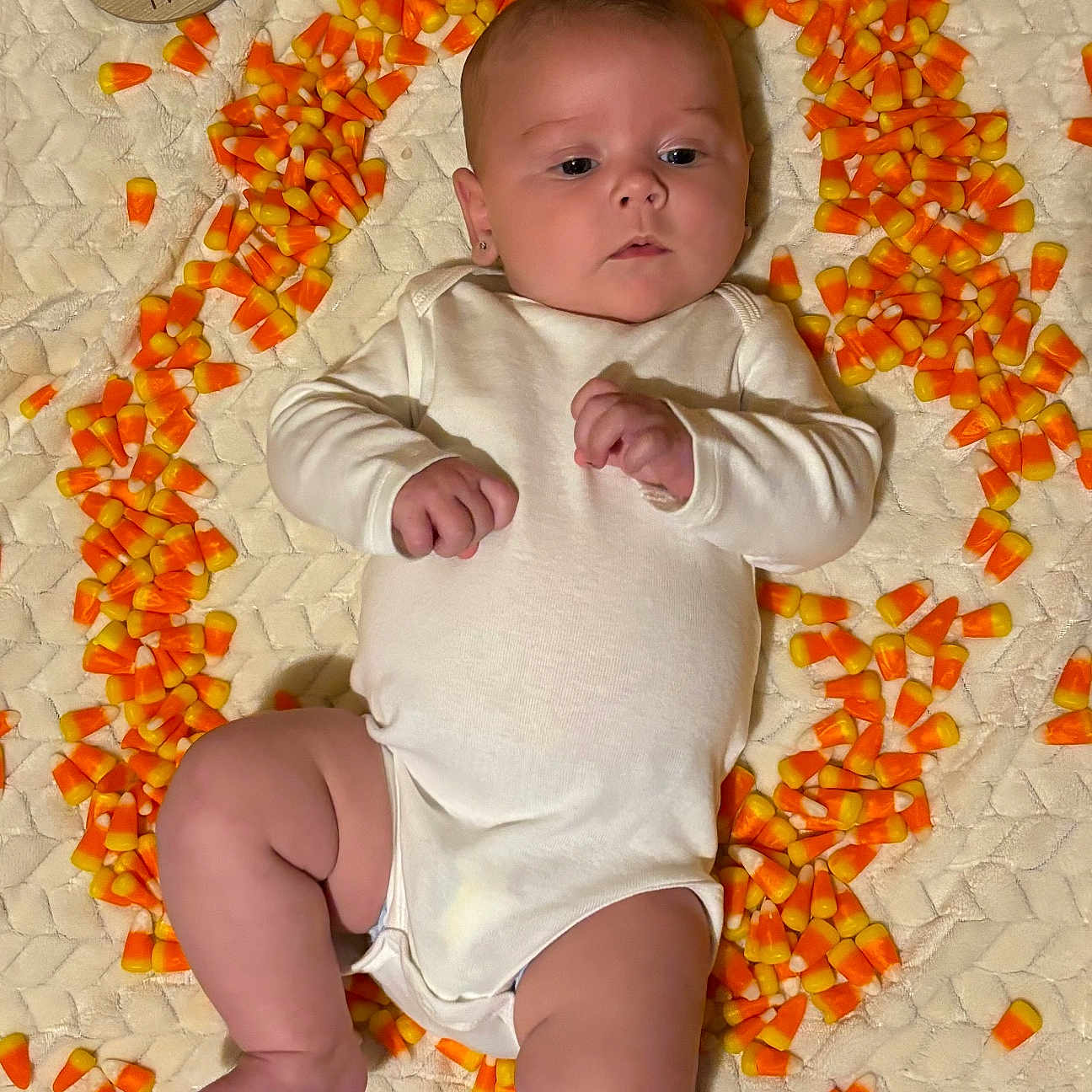 Ireland is registered to the contest to win money with this photo: baby, bodypart, clothing, face, finger, flower, food, hand, happy, head, newborn, person, petal, photography, plant, portrait, produce, quilt, sitting, sleeve