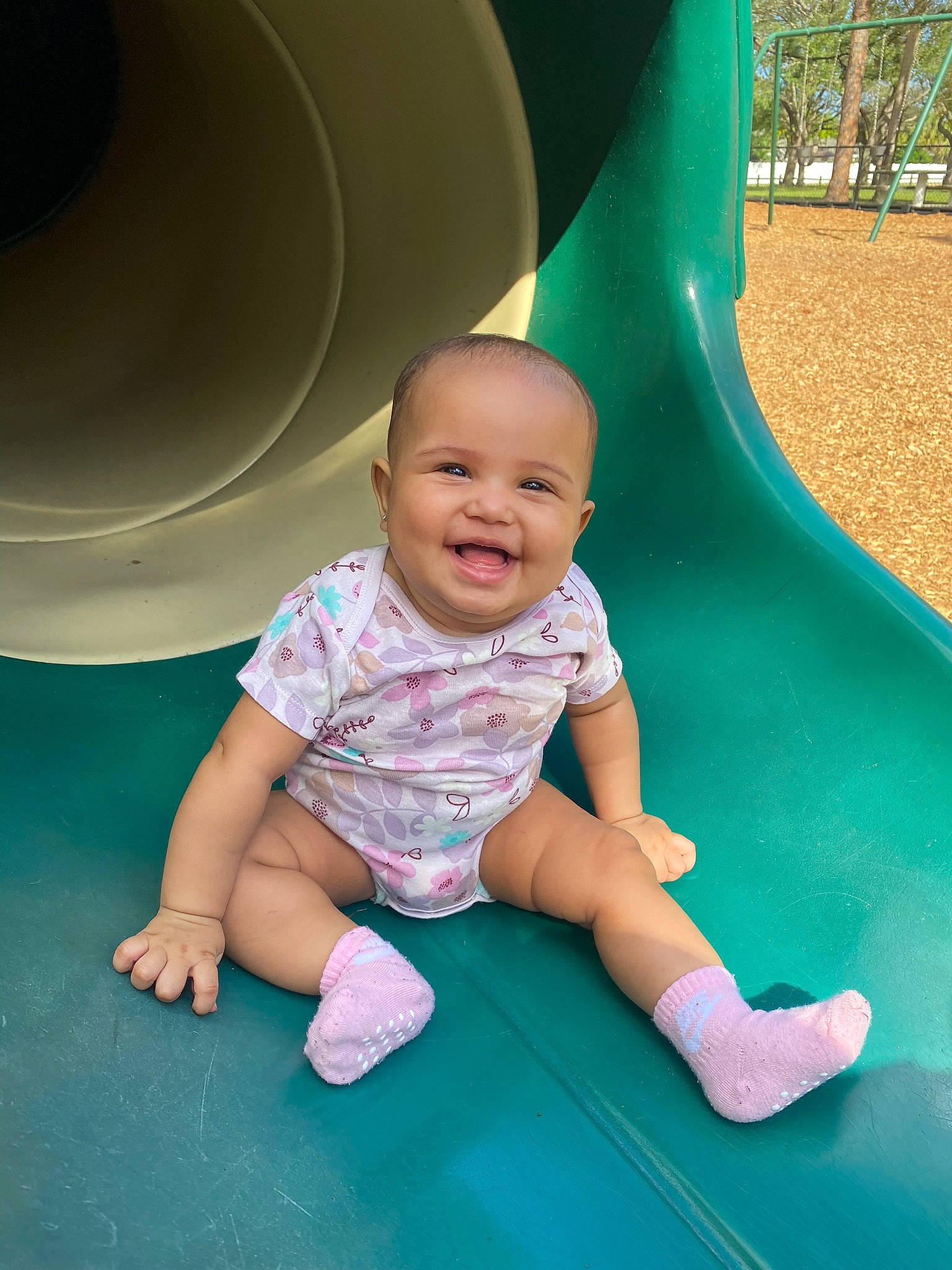 Kalani joined the competition — help win amazing prizes! aqua, baby, baby_toddler_clothing, child, chute, comfort, eye, flooring, fun, grass, green, happy, human_body, joy, leg, leisure, person, playground, playground_slide, recreation