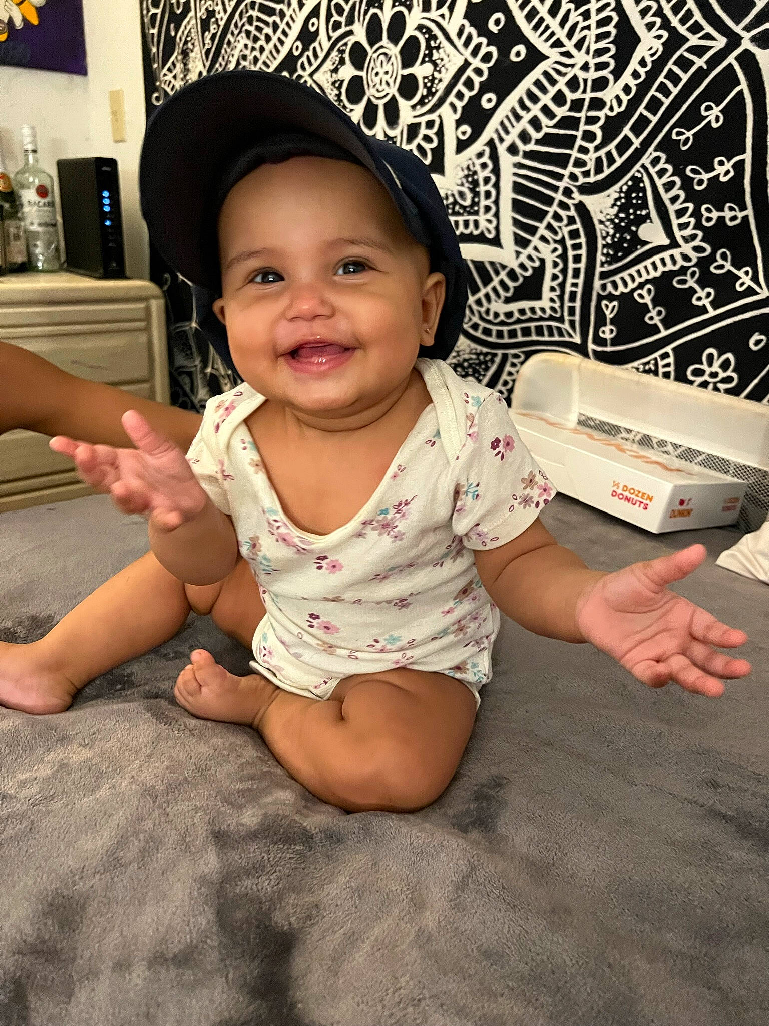 Kalani is registered to the contest to win money with this photo: baby, baby_toddler_clothing, barefoot, child, elbow, eye, fashion_accessory, finger, flash_photography, flooring, foot, fun, happy, headwear, human_leg, joy, person, sitting, skin, sleeve