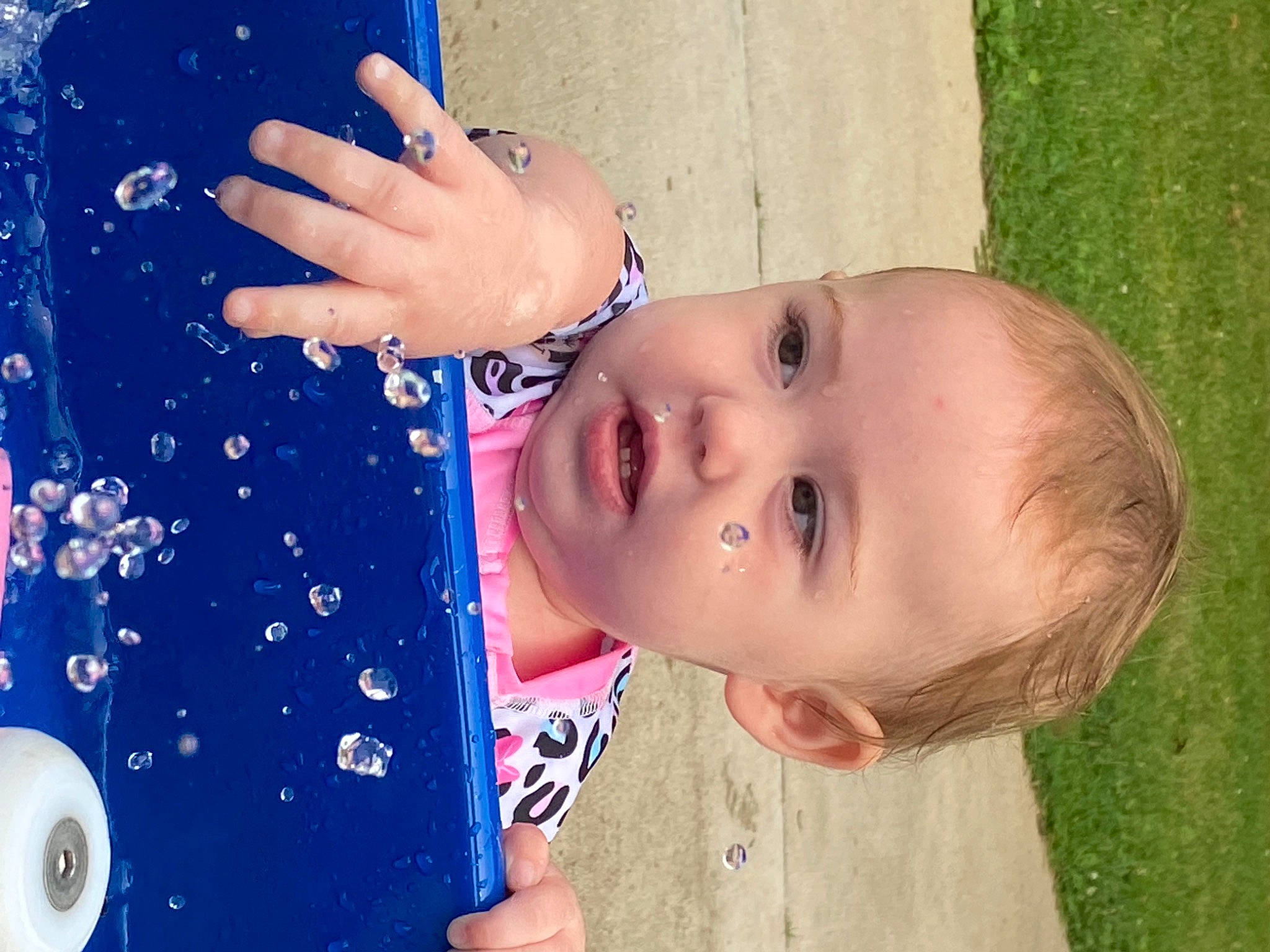 Blair joined the competition — help win amazing prizes! blue, child, electric_blue, eyelash, finger, fun, gesture, grass, happy, leisure, lip, nail, people_in_nature, person, play, recreation, sleeve, toddler, tree, water