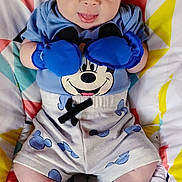 Enzo joined the competition — help win amazing prizes! baby, infant, child, portrait, lying_down, sitting, blue_gloves, boxing_gloves, mickey_mouse, cartoon, romper, socks, blanket, colorful, geometric_pattern, playful, tongue_out, indoor, close_up, happy