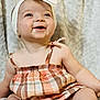 accessories, baby, babylaughing, blonde, clothing, dress, face, hair, happy, hat, head, headband, jewelry, laughing, person, photography, portrait, sitting, sleeve, smile