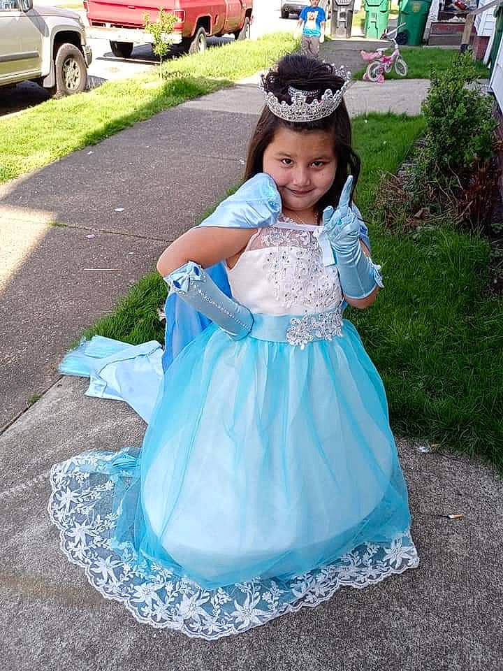 Reina is registered to the contest to win money with this photo: baby_toddler_clothing, child, dress, electric_blue, event, formal_wear, fun, gown, grass, happy, hat, headpiece, joy, magenta, person, plant, recreation, smile, tire, toddler