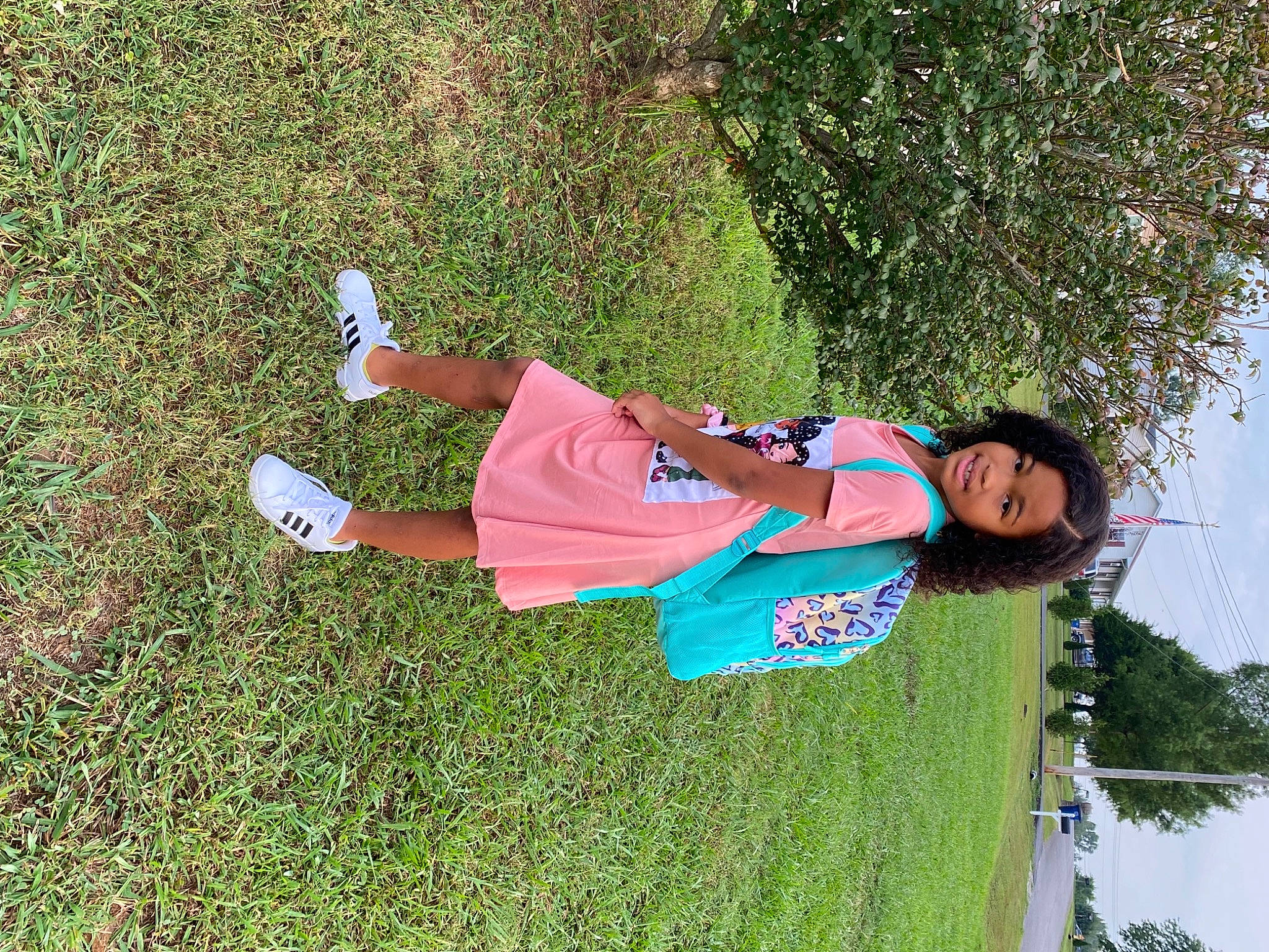 Alexandra is registered to the contest to win money with this photo: fun, grass, grassland, happy, lawn, leisure, people_in_nature, person, plant, recreation, sky, smile, t_shirt, toddler, tree, water