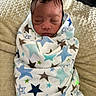 Anthony joined the competition — help win amazing prizes! newborn, baby, sleeping, wrapped, blanket, star_pattern, cozy, soft, cushion, indoor, infant, child, peaceful, face, head, human, portrait, resting, cute, comfort