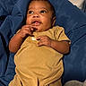 Anthony is registered to the contest to win money with this photo: baby, infant, child, person, face, hand, clothing, blanket, fabric, indoor, cute, skin, expression, curious, lying, newborn, toddler, soft, comfortable, portrait