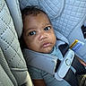 baby, car_seat, child, infant, seatbelt, safety, quilted_fabric, pout, curious, strapped_in, clothing, closeup, indoors, person, portrait, young_child, cute, head, face, seat