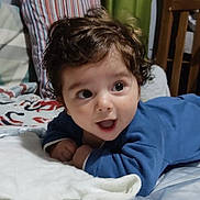 Lenzo joined the competition — help win amazing prizes! baby, infant, curly_hair, blue_clothing, blanket, bed, pillow, crib, smiling, happy, wide_eyes, mouth_open, hands, indoors, bedroom, soft_toy_area, striped_pillow, green_curtain, wooden_furniture, portrait