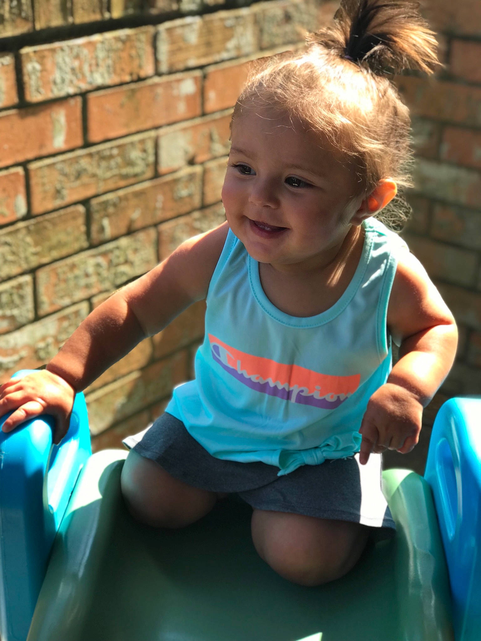 Lizzy is registered to the contest to win money with this photo: baby, blue, child, facial_expression, fun, games, happy, joy, leisure, people, person, play, playground, shoulder, sitting, skin, smile, summer, toddler, turquoise