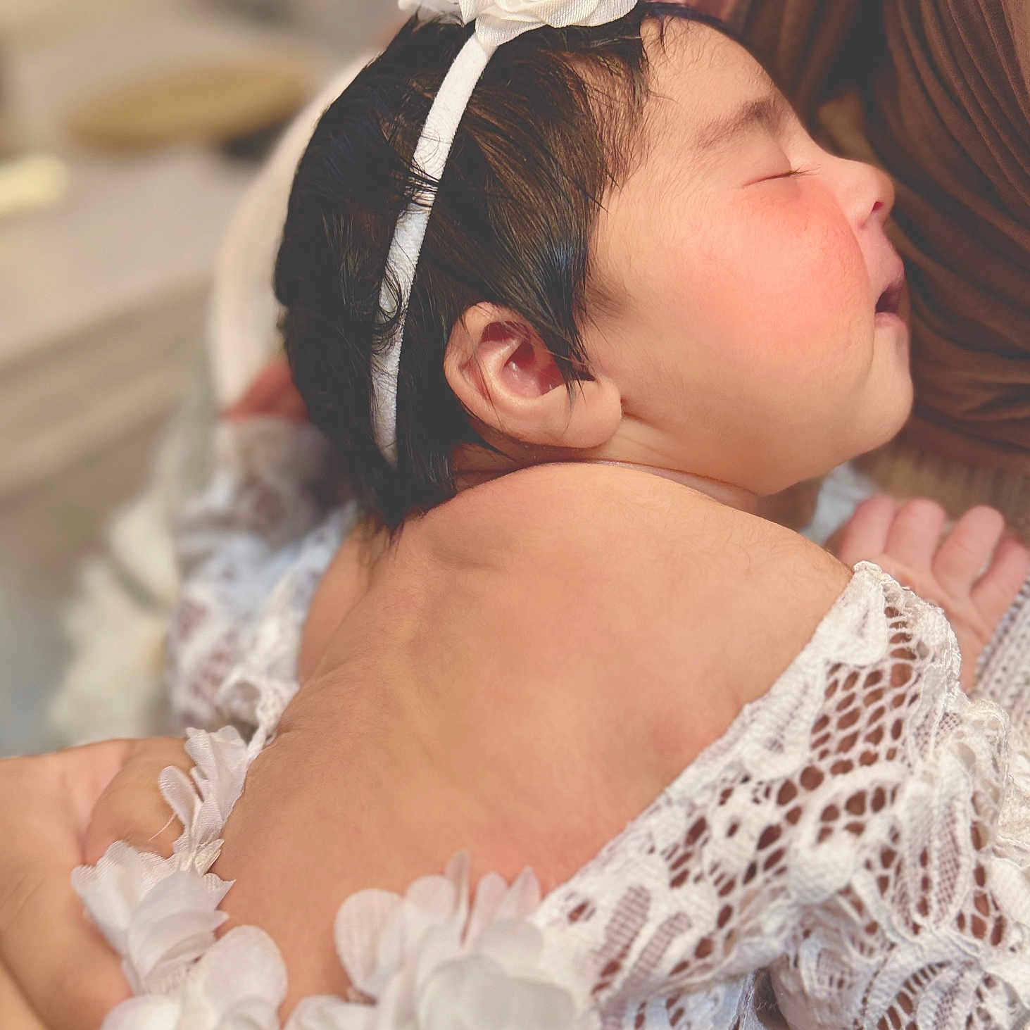 Ain is registered to the contest to win money with this photo: baby, bodypart, bonnet, clothing, dress, face, fashion, finger, formalwear, gown, hand, hat, head, lace, newborn, person, photography, portrait, shoulder, sleeping