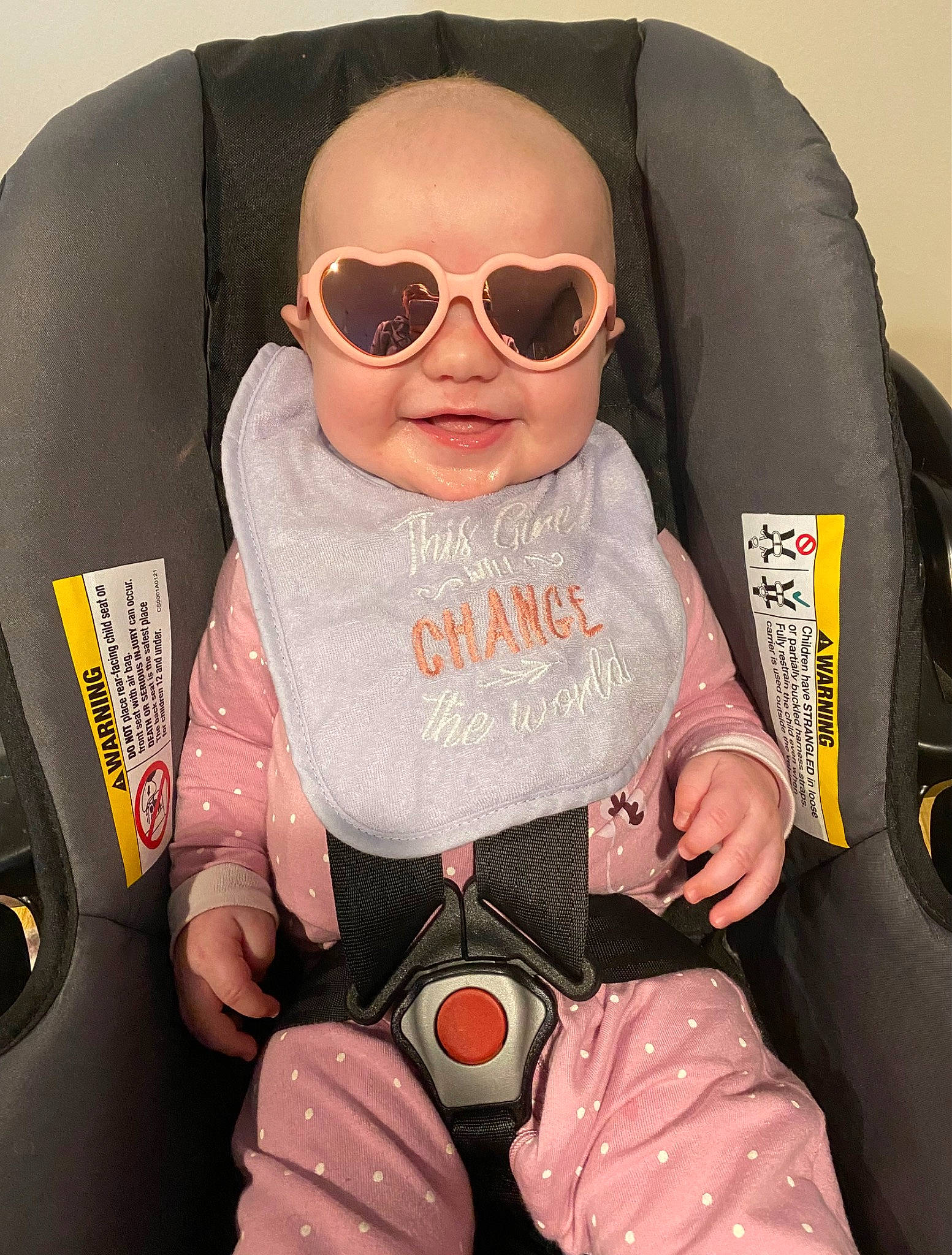 Riley is registered to the contest to win money with this photo: auto_part, baby, baby_carriage, baby_products, baby_toddler_clothing, car_seat, cheek, child, comfort, eyewear, fun, glasses, goggles, person, personal_protective_equipment, seat_belt, sitting, sleeve, sunglasses, toddler