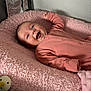 baby, infant, smiling, onesie, pink_blanket, playpen, pacifier, happy, cute, child, newborn, soft_texture, sleepwear, lying_down, indoor, face, skin, hand, cheerful, cozy