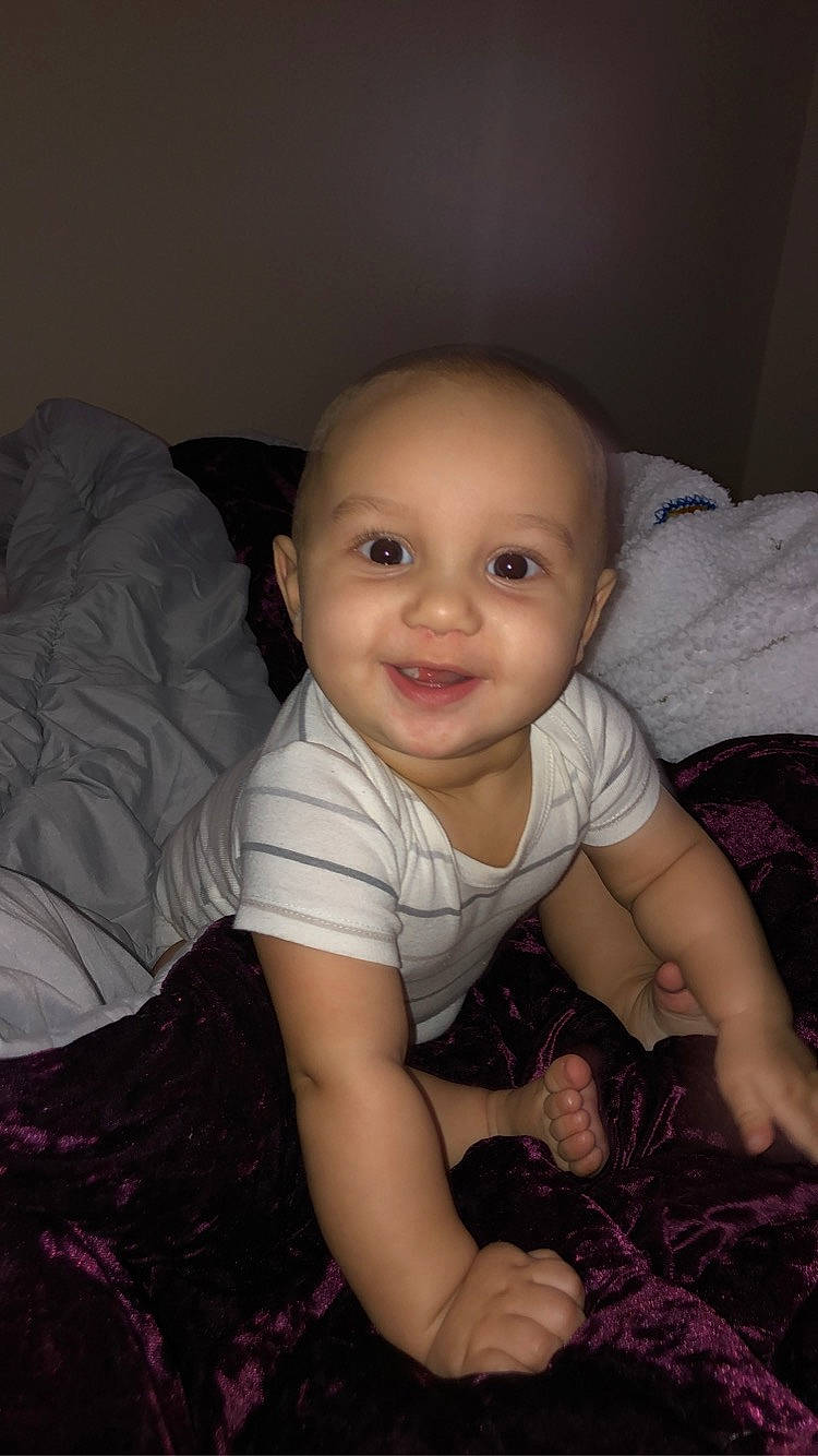 Daxton is registered to the contest to win money with this photo: arm, baby, baby_toddler_clothing, black, cheek, child, comfort, flash_photography, flooring, happy, iris, joy, mammal, mouth, nose, person, pink, skin, smile, toddler