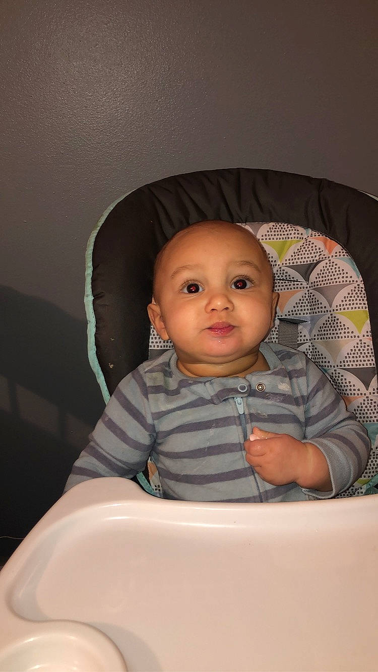 Daxton is registered to the contest to win money with this photo: baby, baby_products, baby_safety, baby_toddler_clothing, chair, cheek, child, comfort, flash_photography, fun, happy, iris, person, room, sitting, sleeve, t_shirt, toddler