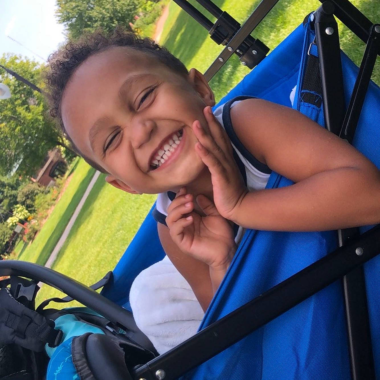 Milo joined the competition — help win amazing prizes! blue, child, cool, electric_blue, fun, grass, happy, joy, leisure, outdoor_play_equipment, outdoor_recreation, person, plant, recreation, sitting, smile, steering_wheel, swing, toddler, travel