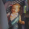 baby_clothes, bmw, car_interior, car_seat, child, cute, daytime, face_stickers, happy, parked_car, portrait, rear_seat, rear_view_mirror, safety_harness, seatbelt, smile, sunlight, toddler, vehicle, window