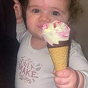 Zaina a rejoint le concours — aidez-le/la à gagner de superbes lots ! toddler, child, ice_cream, cone, curly_hair, long_sleeve_shirt, indoor, hand, face, expression, food, sweet, messy, cute, clothing, person, closeup, skin, eyes, mouth
